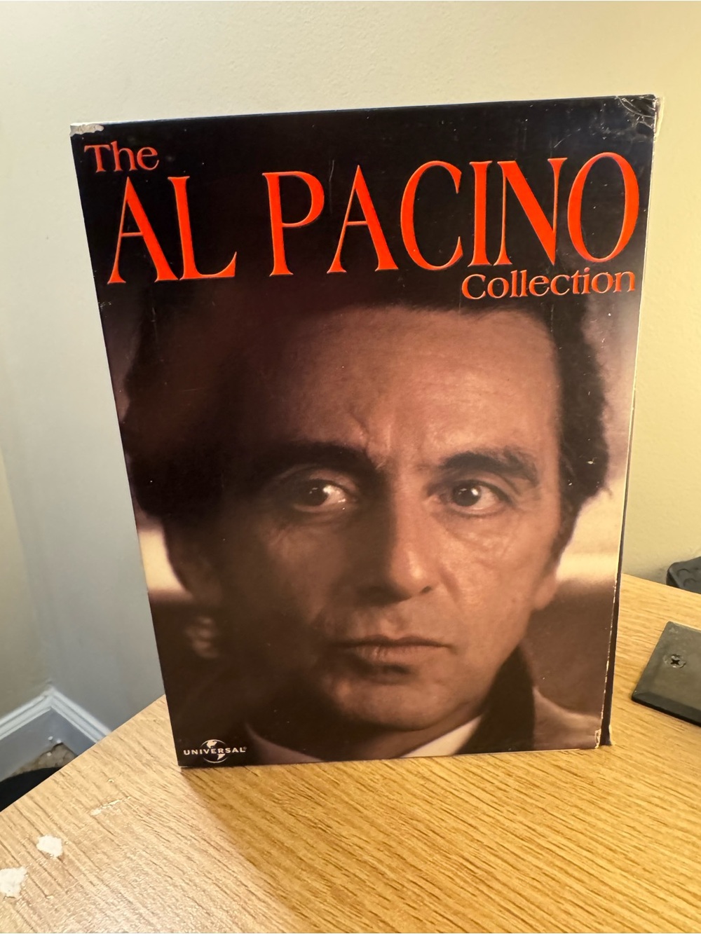 Universal Coffee Table Book with Bold Red Typography and Brown Portrait